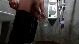 A chap in sweatpants voids urine and cums in a glass for his ally, who then drinks it