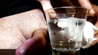 Closeup Thick Ejaculation Into a Glass of Cold Water