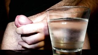 Closeup Thick Ejaculation Into a Glass of Cold Water