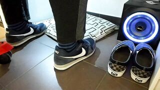 Boy shoeplay and stomping stuff at home in Nikes, Vans, blue stiped socks