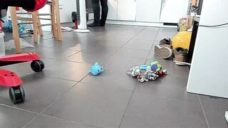 Boy shoeplay and stomping stuff at home in Nikes, Vans, blue stiped socks