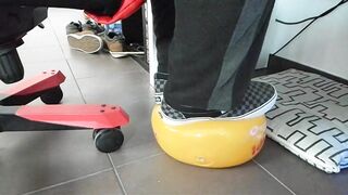 Boy shoeplay and stomping stuff at home in Nikes, Vans, blue stiped socks