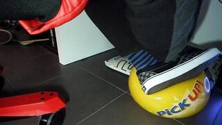 Boy shoeplay and stomping stuff at home in Nikes, Vans, blue stiped socks