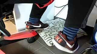 Boy shoeplay and stomping stuff at home in Nikes, Vans, blue stiped socks