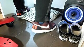 Boy shoeplay and stomping stuff at home in Nikes, Vans, blue stiped socks