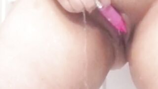 Playing in the shower, legs shaking with joy.
