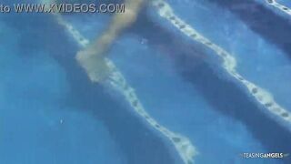 Disinterested lesbo companions are engaging in inappropriate behavior in the outdoor pool whilst sunbathing.