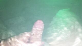 Underwater wank session in backyard in steamy sexy tub glowing at night.