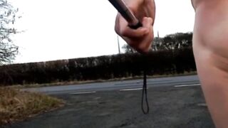 Bare with and out of jock pump at side of busy road