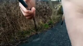 Bare with and out of jock pump at side of busy road