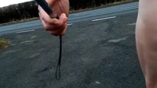 Bare with and out of jock pump at side of busy road