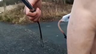 Bare with and out of jock pump at side of busy road
