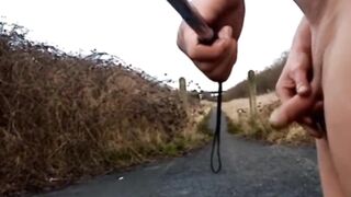 Bare with and out of jock pump at side of busy road