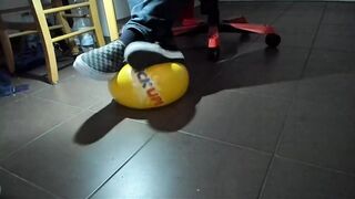 Boy Shoeplay with beach ball in Underneath Armor, Vans Slide Ons, Ebony Socks